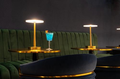 a couple of tables with a blue drink on them at Novotel World Trade Centre Dubai in Dubai