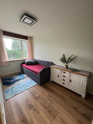 a living room with a couch and a window at Modern apartment in Rõuge in Rõuge