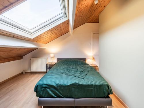 a bedroom with a bed and a skylight at Merksplas Villa with Terrace in Merksplas