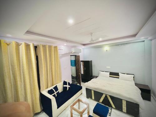 a bedroom with a bed and a chair in it at Hotel regal garden in Faridabad