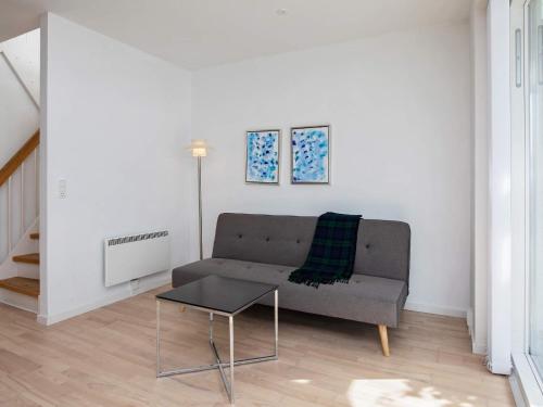 a living room with a couch and a table at 6 person holiday home in Væggerløse-By Traum in Marielyst