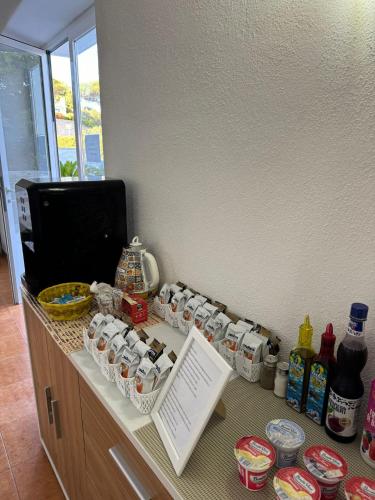 a counter with bottles and cans on top of it at Villa Chiena Forio in Ischia