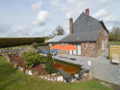 a house with a swimming pool in the yard at Luxury Pool Villa in Goesnes in Goesnes