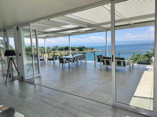 a patio with a view of the ocean from a house at Lake Kariba Inns in Siavonga