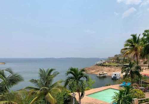 a view of a body of water with palm trees at Lake Kariba Inns in Siavonga