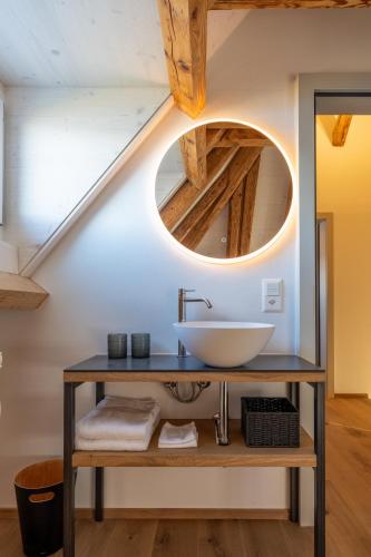 a bathroom with a sink and a mirror at Le Ruedli - Villa 1878 in Spiez