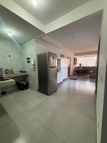 a large kitchen with a stainless steel refrigerator at Lorenna Reservas in Araxá