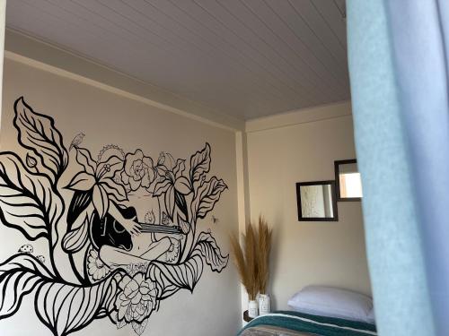 a bedroom with a painting on the wall at Artsy B in Gaborone