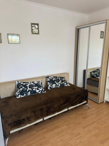 a couch in a room with a mirror at Домик у моря в Фонтанке in Odesa