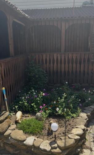 a garden in front of a fence with flowers at Домик у моря в Фонтанке in Odesa