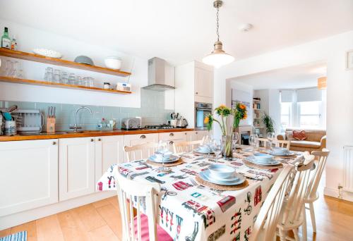 a kitchen with a dining room table with chairs at Perfect Booking Near Ramsgate Station And Beach in Ramsgate
