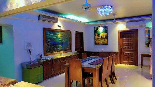 a dining room with a table and some chairs at Luxury Furnished Apartment in Dhaka
