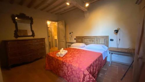 a bedroom with a bed and a dresser and a mirror at Hotel Villa Sermolli in Borgo a Buggiano