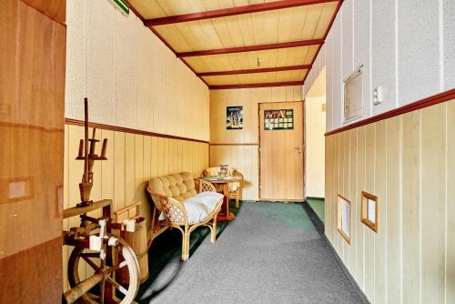 a hallway with a room with a table and chairs at Penzion U Čutňáka in Karlovy Vary