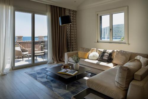 a living room with a couch and a table at Lustica Bay Marina Village by 2BHome in Lustica