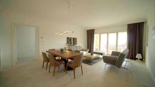 a living room with a dining room table and chairs at Lustica Bay Marina Village by 2BHome in Lustica