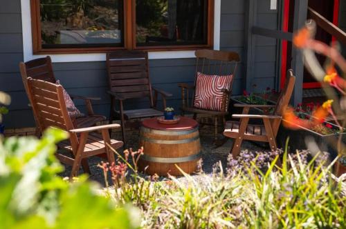 a group of chairs sitting on a porch next to a barrel at Blue Mountains Urban Farm Stay near Sydney in Hazelbrook