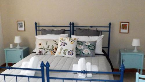 a bedroom with a blue and white bed with pillows at Domus Tua in Pietrelcina