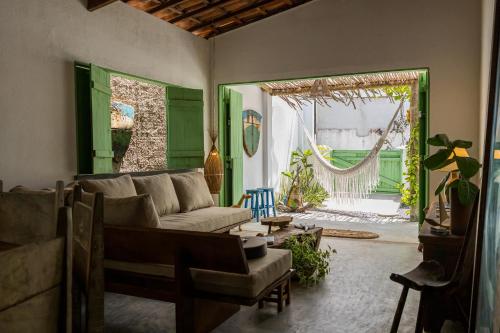 a living room with a couch and a hammock at Casa Mangará in Cruz