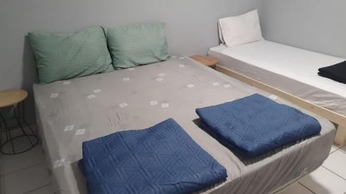 a bunk bed with two blue pillows on it at דירות לב אילת - lev eilat - מרחק 500 מטר מהים קניון וטיילת - מקבלים נוער in Eilat