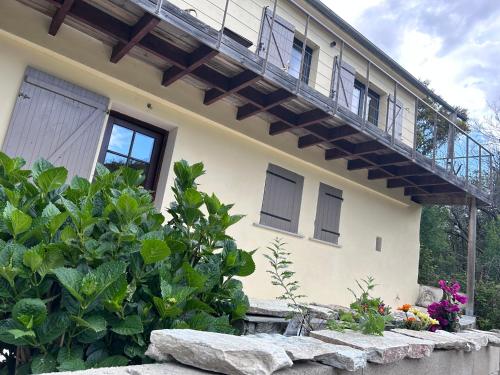 a house with a balcony on top of it at Sisco Nature in Sisco