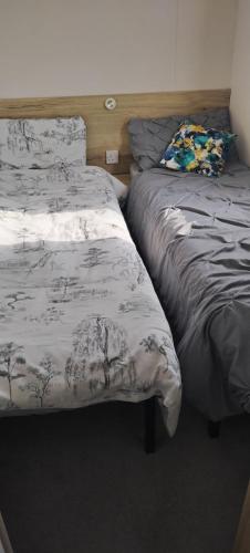 two beds sitting next to each other in a bedroom at Beach Haven at Berwick in Berwick-Upon-Tweed