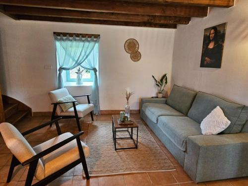 a living room with a couch and a table at Holiday Home in Pionsat near Volcano Park in Pionsat