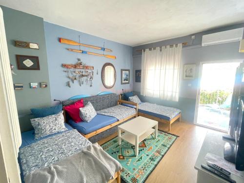 a living room with a couch and a table at Small house at seafront in Tisno