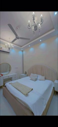 a bedroom with a large bed with a ceiling at صلالة in Salalah