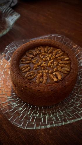 a chocolate cake with nuts on top of a glass plate at Oka Pousada Atins in Atins