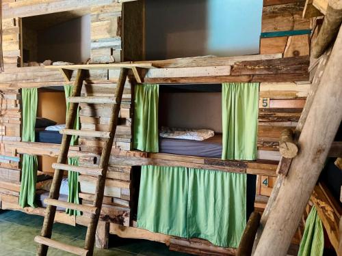 a set of bunk beds in a log cabin at Santa Cruz Surf House by Stoke Travel in A dos Cunhados