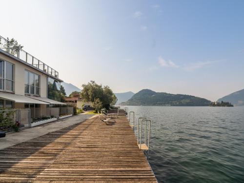 a wooden dock next to a body of water at Lakefront Retreat with Garden in Marone