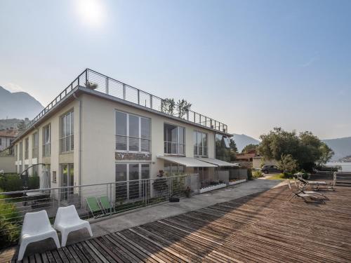 a house with two white chairs on a deck at Lakefront Retreat with Garden in Marone