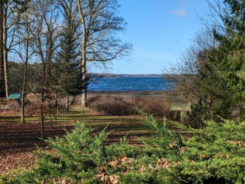 a view of the water from a park with trees at Cozy Stuer Nature Escape in Stuer