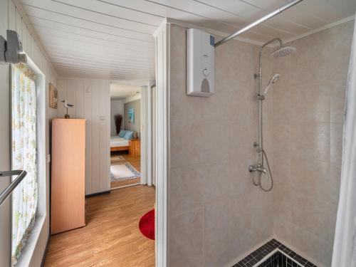 a bathroom with a walk in shower next to a room at Cozy Stuer Nature Escape in Stuer