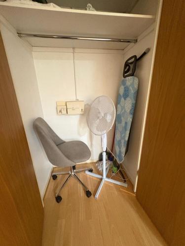 a chair and a fan in a room at Misk Homes #3 Near Heathrow Airport, shops & Brunel University - Free Parking in Uxbridge