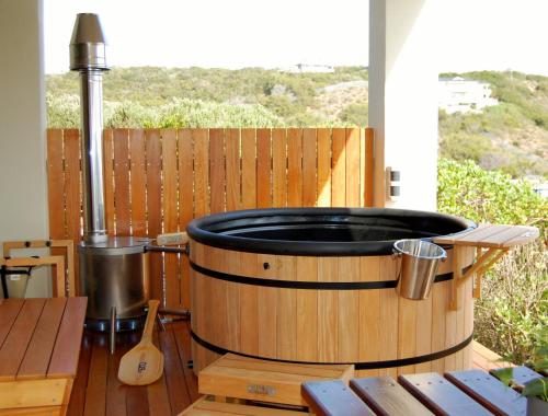 a hot tub sitting on top of a wooden table at 3onPacific in Sedgefield