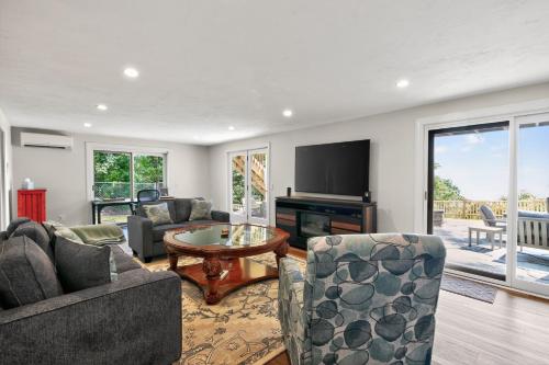a living room with two couches and a television at Ocean Views & Private Beach 3BR Nature Escape villa in Nameloc Heights