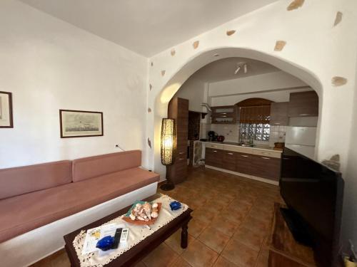 a living room with a couch and a table at Atlazia Suites in Alinda