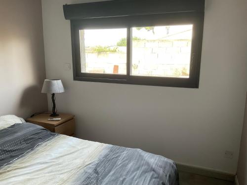 a bedroom with a bed and a window at Marco Christophe Regine in Saturargues