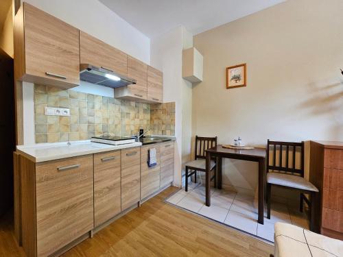 a kitchen with a sink and a table in a room at Fatrapark 1 Apartments in Ružomberok