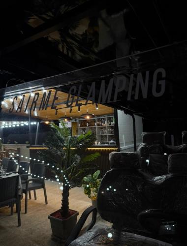 a restaurant with a table and chairs and a plant at Sairme Glampings in Sairme