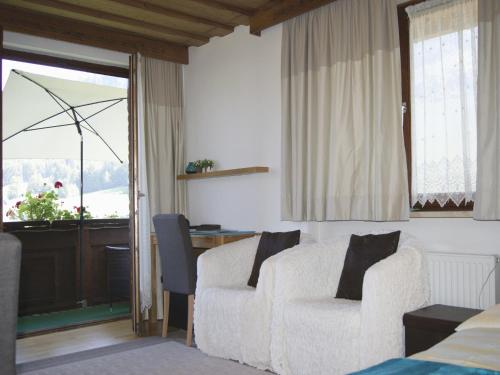 a living room with a couch and a chair and a window at Apartment am Wolfgangsee in Strobl