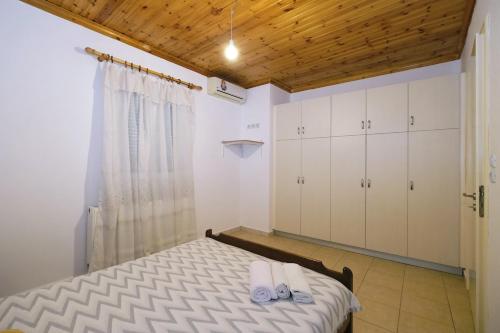 a bedroom with a bed and white cabinets at Convenient Apartment in Limnos Near Port in Mirina