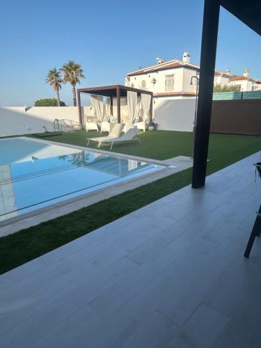 a view from the balcony of a house with a swimming pool at Chalet con vistas al atlantico in Palos de la Frontera