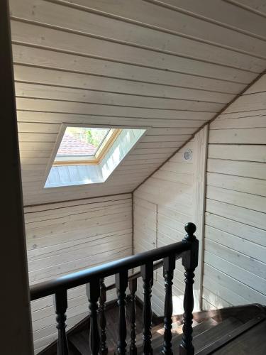 a skylight in a room with a wooden ceiling at Біля Плаю in Plav'ya