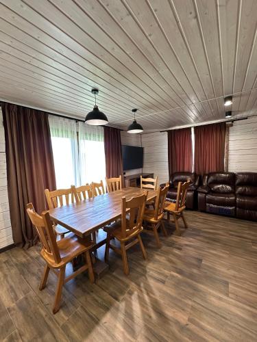 a conference room with a wooden table and chairs at Біля Плаю in Plav'ya
