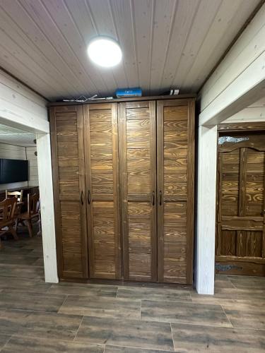 a row of wooden lockers in a room at Біля Плаю in Plav'ya