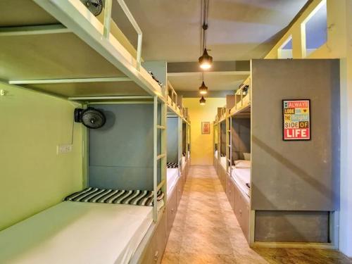 a hallway with three bunk beds in a room at Seeya Heritage Hostels in North goa
