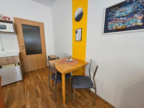 a small dining room with a table and chairs at Fatrapark 1 Apartments in Ružomberok